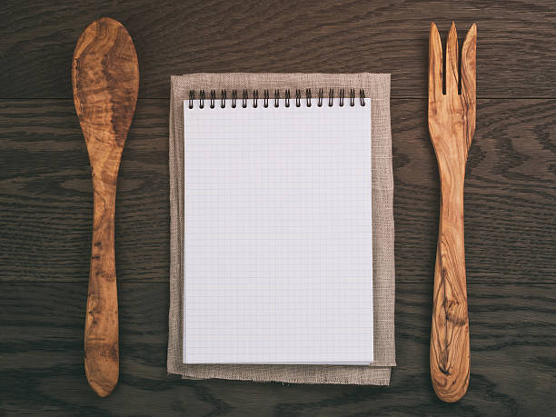 istock notebook with spring on wood table with wooden utensils 578082264
