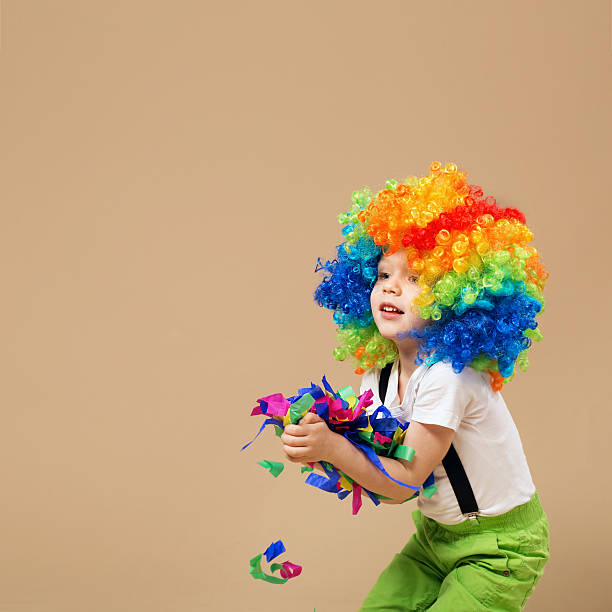 istock Happy clown boy with large colorful wig. 578082308