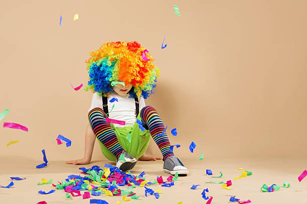 istock Happy clown boy with large colorful wig 578082436