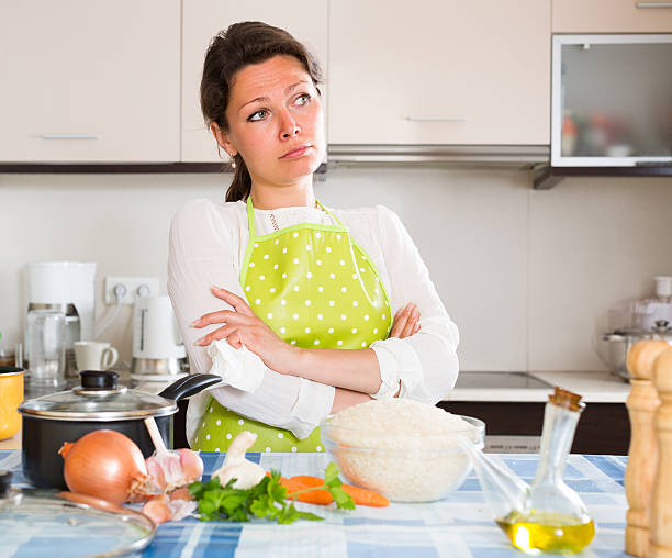 istock Sad housewife cooking dinner 578083712