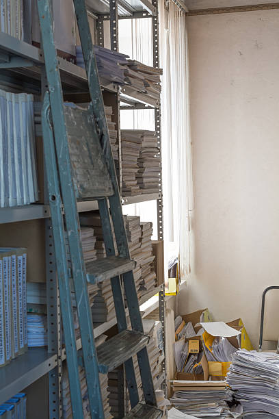 istock Mess in the archive. Old folding ladder. 578083746