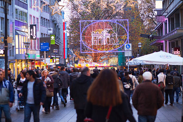 Essen, Germany - November 7, 2015: Capture of crowd of people doing xmas shopping in light decorated street and pedestrian zone Kettwiger Straße at xmas season and weeks of lights.