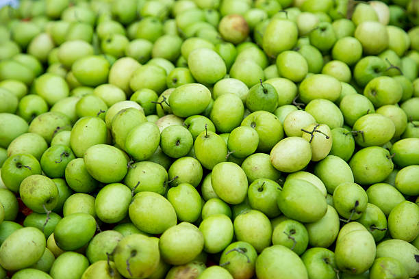 Green star apples fruits A lot of green star apples, chrysophyllum cainito at a market in Vietnam chrysophyllum cainito stock pictures, royalty-free photos & images
