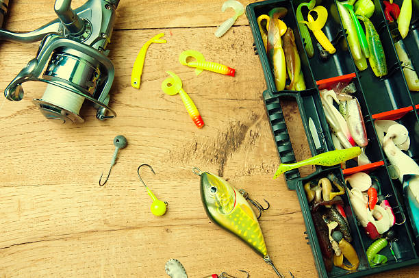 istock Fishing baits and rod isolated on wooden background 578084664