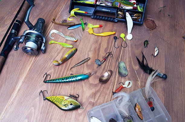 istock Fishing baits and rod isolated on wooden background 578085082