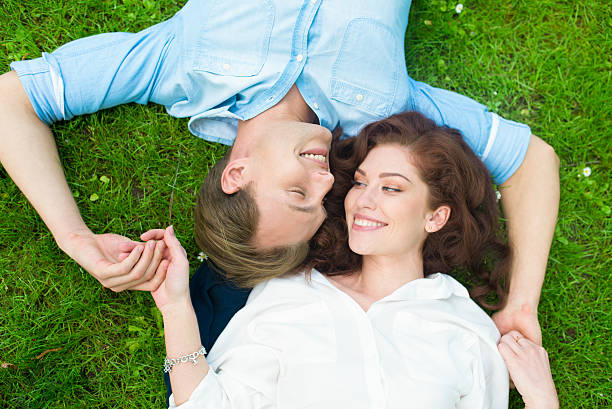 istock Happy couple relaxing on the grass 578086058