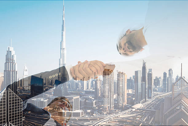 Business in Gulf Conceptual image of Business in Middle East. Arab man and a European businessman shaking hands over the city of Dubai, United Arab Emirates expatriate photos stock pictures, royalty-free photos & images