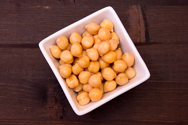 istock Boiled chickpeas on a square bowl on wooden from above 578090412