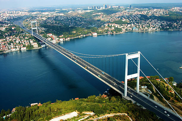 aerial View of the Bosphorus Bridge and the strait below Istanbul, Bosphorus Bridge, Bridge - Man Made Structure, Large, Aerial View bosphorus photos stock pictures, royalty-free photos & images