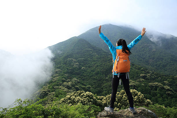 istock young woman backpacker hiking at forest mountain top 578092242