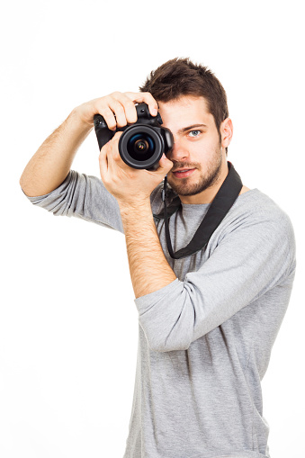 Amateur photographer holds camera in hands, prepare to make shot, isolated on white background.