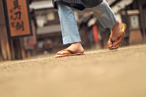 Foot of man in Zouri The feet of a man in zori geta sandal stock pictures, royalty-free photos & images