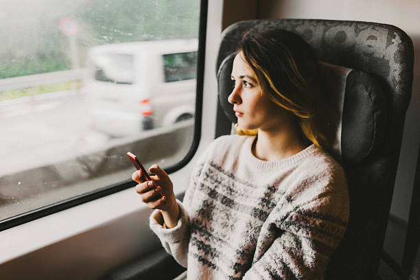 istock Woman in train with smartphone 578095382