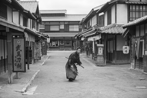 warrior samurai costume man in toei studios at kyoto japan - black and white