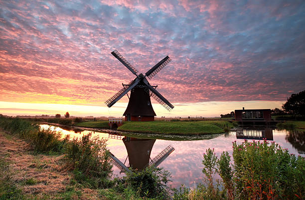 istock spectacular sunrise over farmland with windmill 578101738