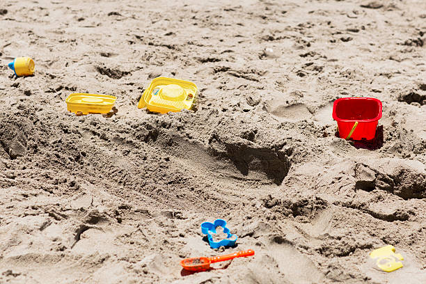 istock Children's toys lying on the sand. 578102936