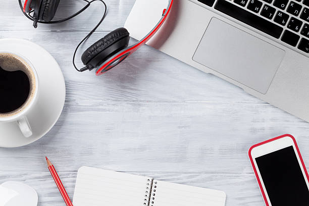 istock Desk table with laptop, coffee and headphones 578103554