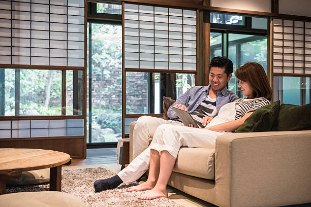 istock Man using tablet sitting on sofa with pregnant woman 578106282