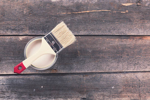 istock paint can with paintbrush on old wooden background 578109384
