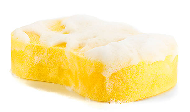 Cleaning Sponge with Soap Sud Yellow household cleaning sponge with soap sud isolated on white background. bath sponge photos stock pictures, royalty-free photos & images
