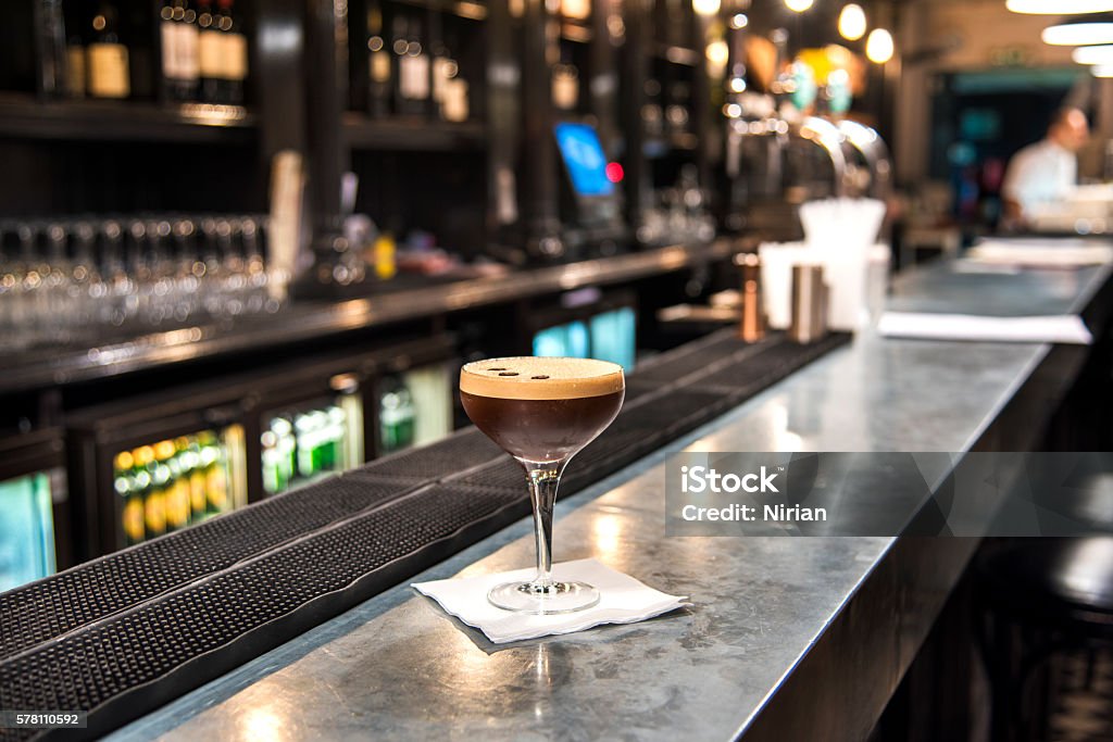 Espresso Martini The espresso martini alcoholic cocktail drink on the long bar with blur background. Espresso Stock Photo