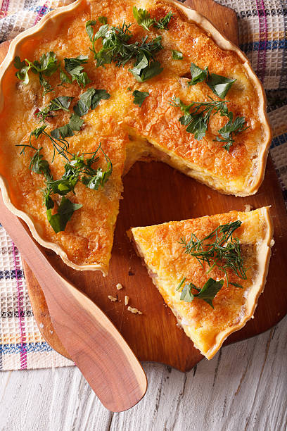istock Sliced quiche with cheese, eggs and bacon close-up. vertical 578110994
