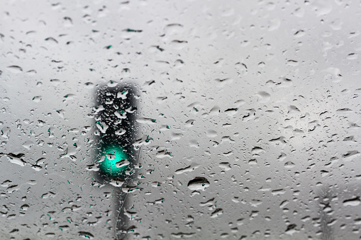 Abstract Blur - Traffic light on a rainy day window background
