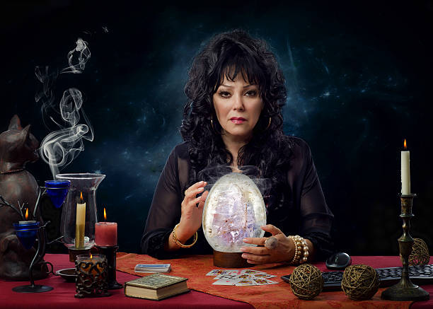 portrait psychic with big crystal egg - clairvoyance imagens e fotografias de stock