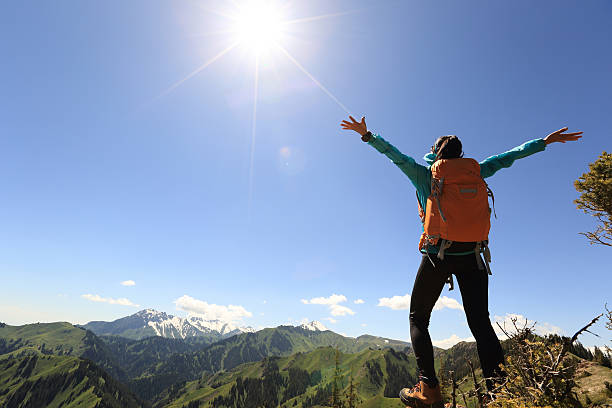 istock cheering successful woman backpacker open arms on mountain peak 578113920