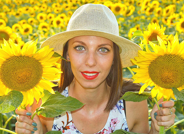 istock Young woman in sunflower field 578114892