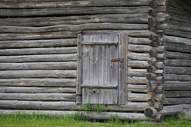 istock Small door in old traditional log hut 578115210