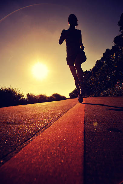 istock young woman runner running on sunrise seaside 578118026