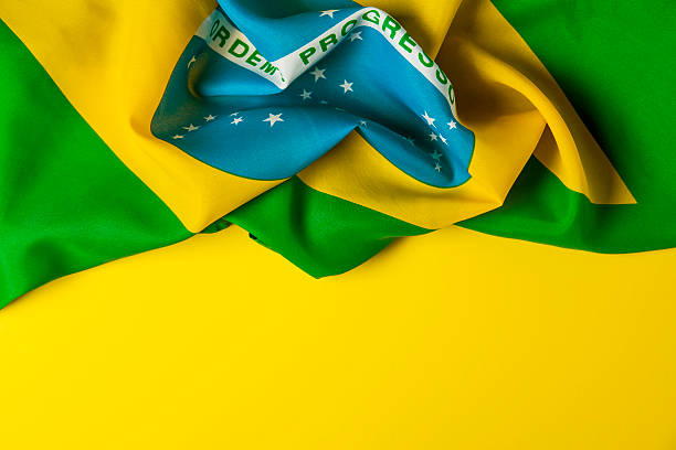 istock Brazilian flag on a plain yellow background 578119270
