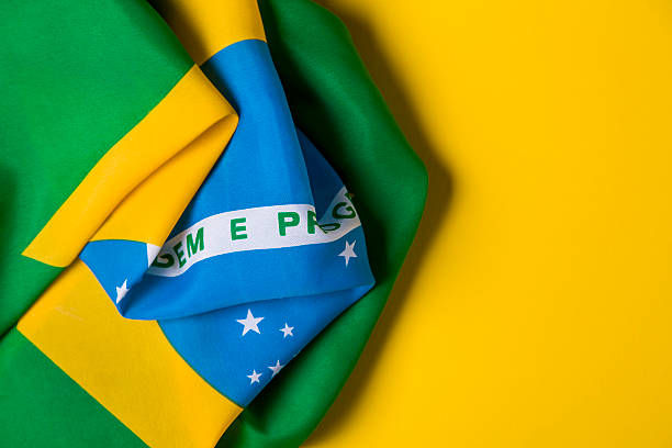 istock Brazilian flag on a plain yellow background 578119272
