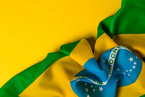 istock Brazilian flag on a plain yellow background 578119276