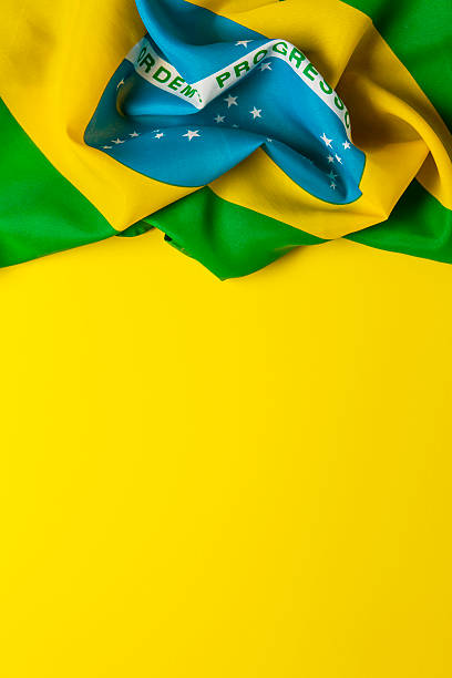 istock Brazilian flag on a plain yellow background 578119300