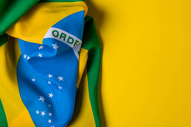 istock Brazilian flag on a plain yellow background 578119302