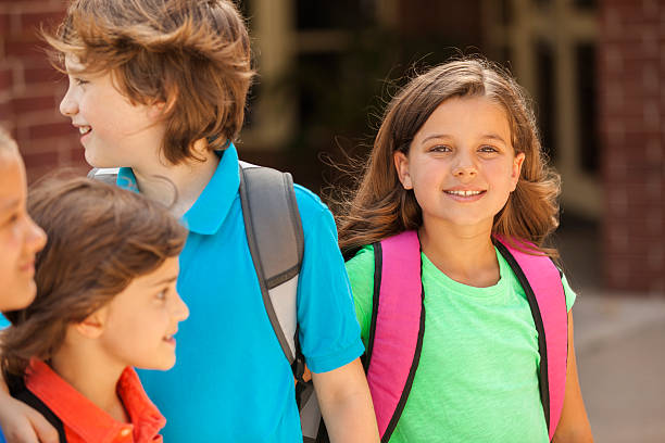 istock Back to School:  Elementary-age children, friends on school campus. 578119734