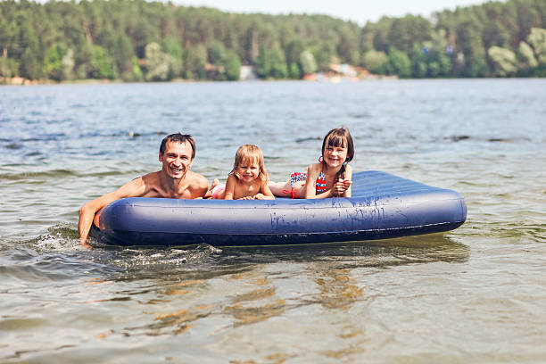 istock Family floating on mattresses. 578121178