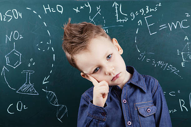 istock Little boy near blackboard with formulas 578267322