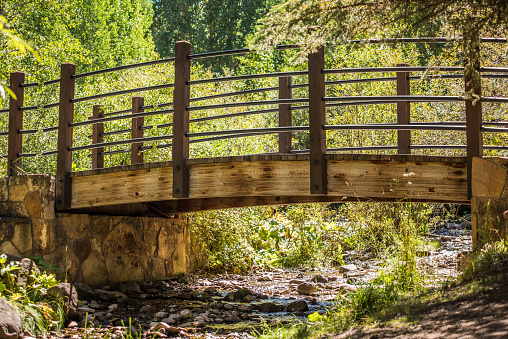 Small fairytale bridge with creek in Vail, Colorado during summer