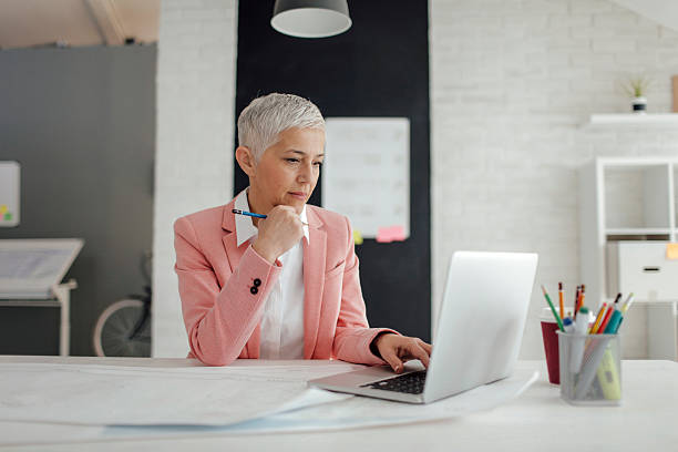 Mature Businesswoman Working In Her Office.