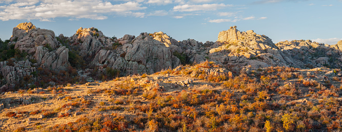 Morning sunlight is hitting the Crab Eyes rock formation, during fall, in the Wichita Mountains of Oklahoma.