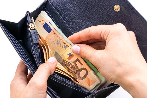 istock Blue purse with euros in the hands on white background 578271080