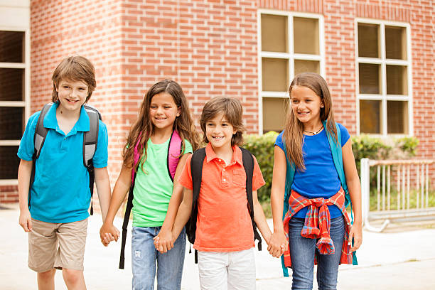 istock Back to School:  Elementary-age children, friends on school campus. 578271098