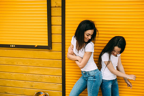istock mother and her cute daughter, against wall 578271268