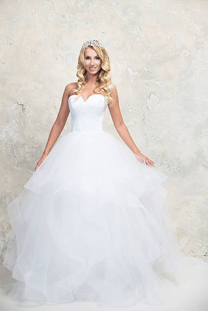 istock Bride in white wedding dress with crown. Blonde 578273292