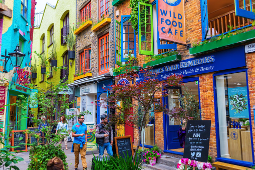 London, UK - June 16, 2016: Neals Yard with unidentifed people. It is a small alley in Covent Garden with colorful houses. It contains several health food cafes and values driven retailers