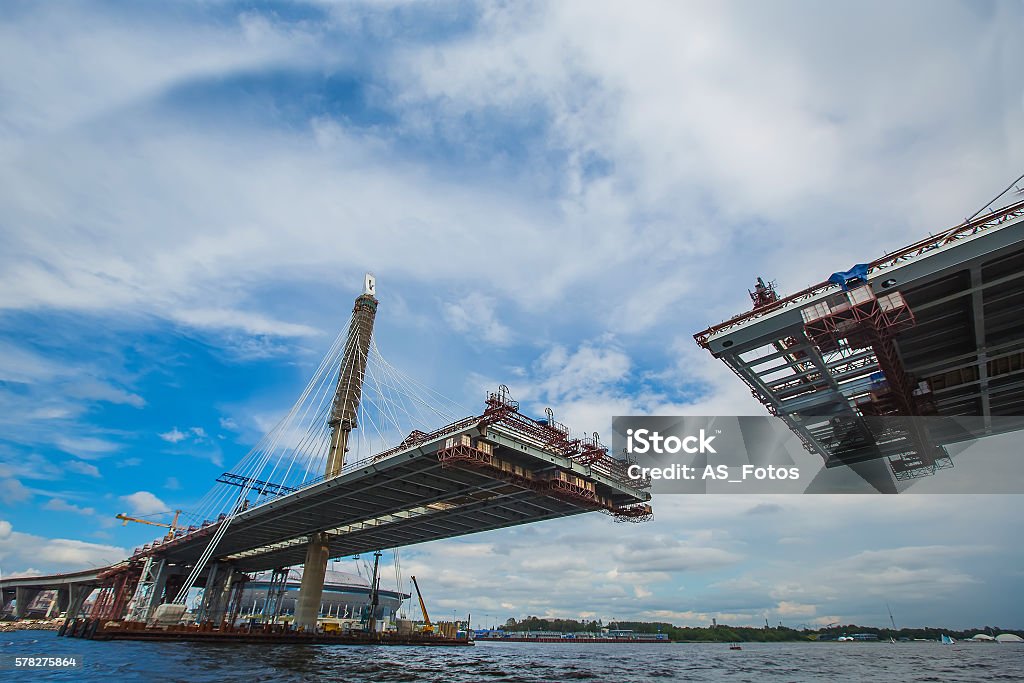 beautiful cable-stayed bridge in the construction process. summe Construction Industry Stock Photo