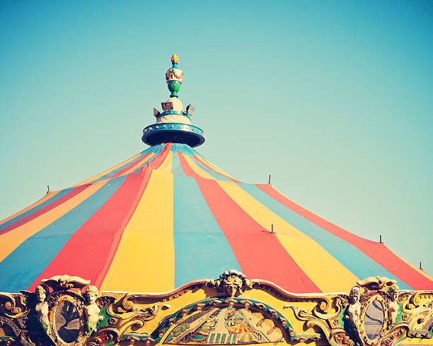 istock Vintage carousel tent on blue sky 578276462